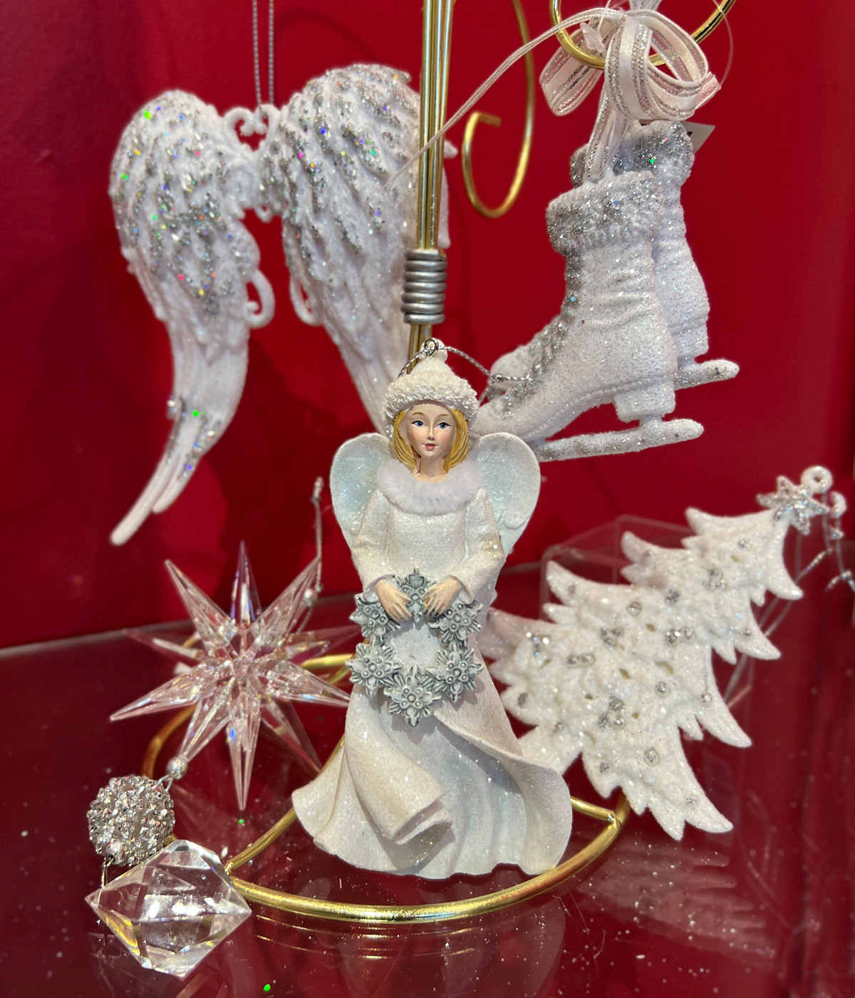 White ornaments including angel wings, christmas tree, skates and angel.